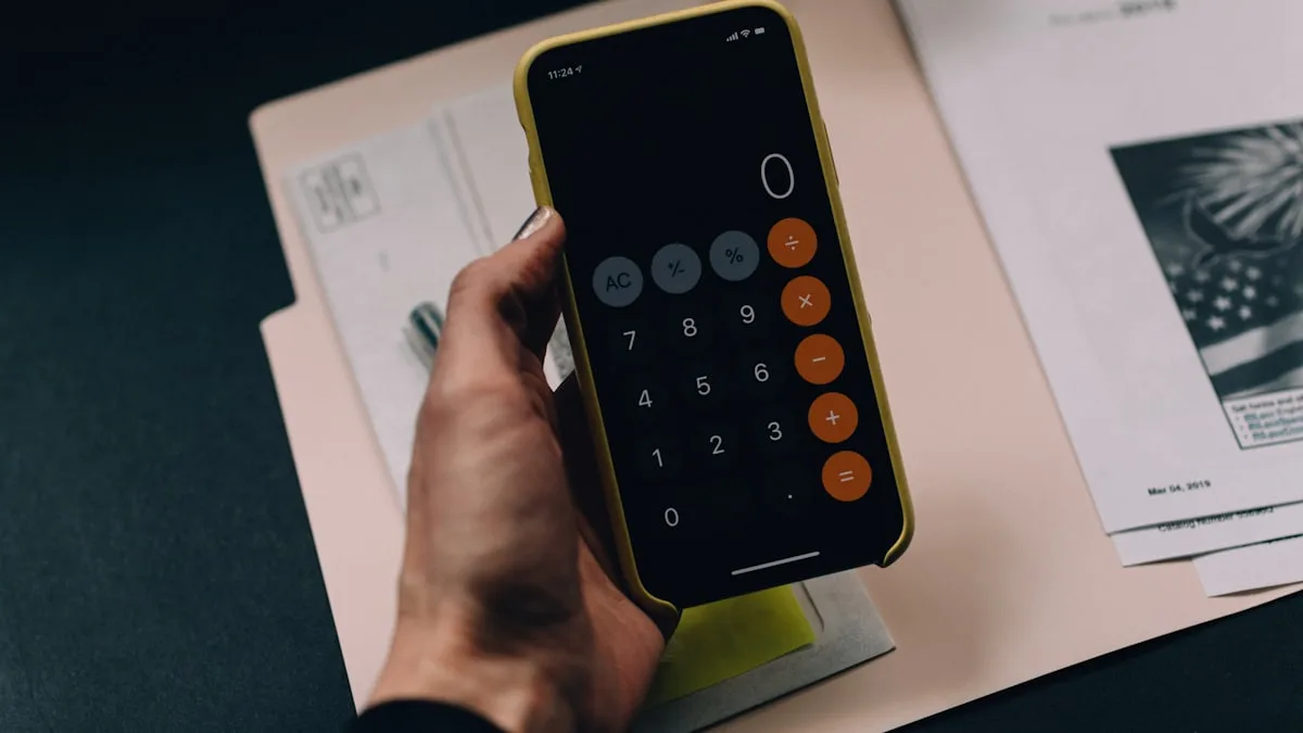 A hand using a phone calculator over financial documents, representing the hidden costs of timeshare ownership