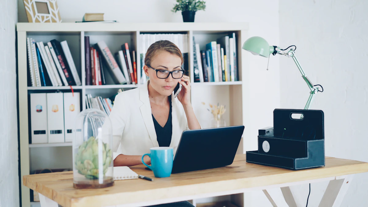 A woman on a phone call at her desk with a laptop and notebook, representing an owner calling the resort to ask about a deed-back or exit program