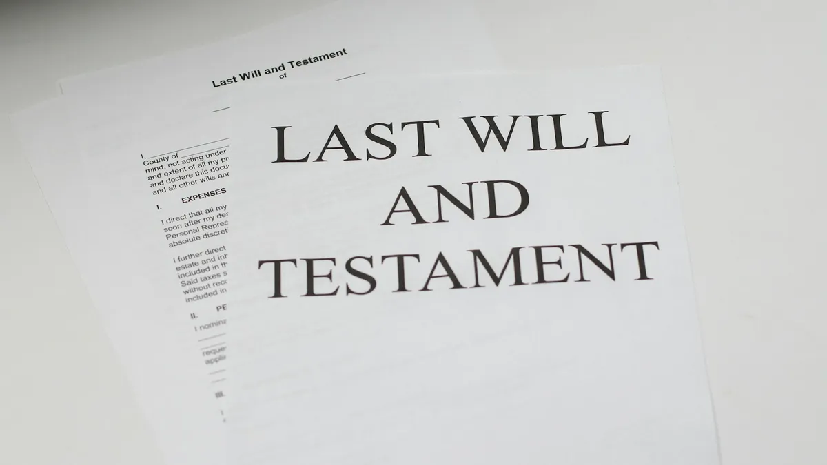 Printed last will and testament documents lying on a desk, representing the estate paperwork that decides how a U.S. timeshare interest passes to heirs