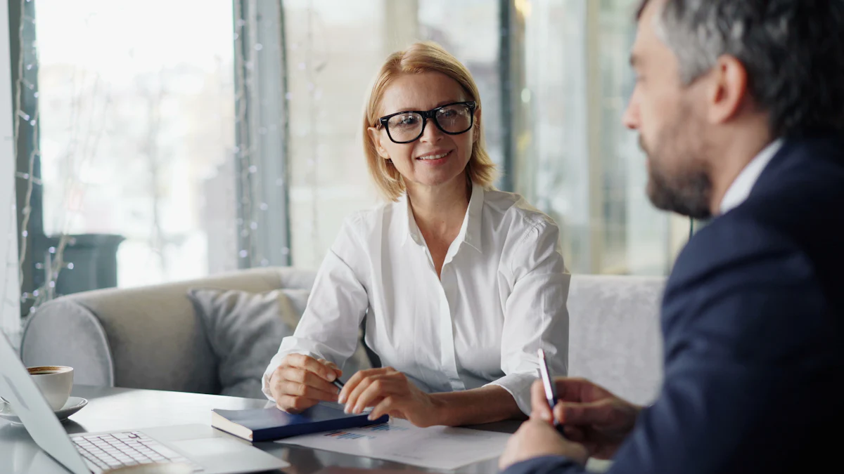A smiling advisor meeting with a client at a table, representing the first consultation with a timeshare cancellation company