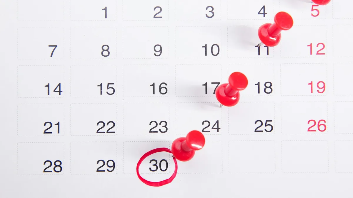 A calendar with red pins and a date circled in red, representing the seven year window that negative timeshare payment history can remain on a U.S. credit report
