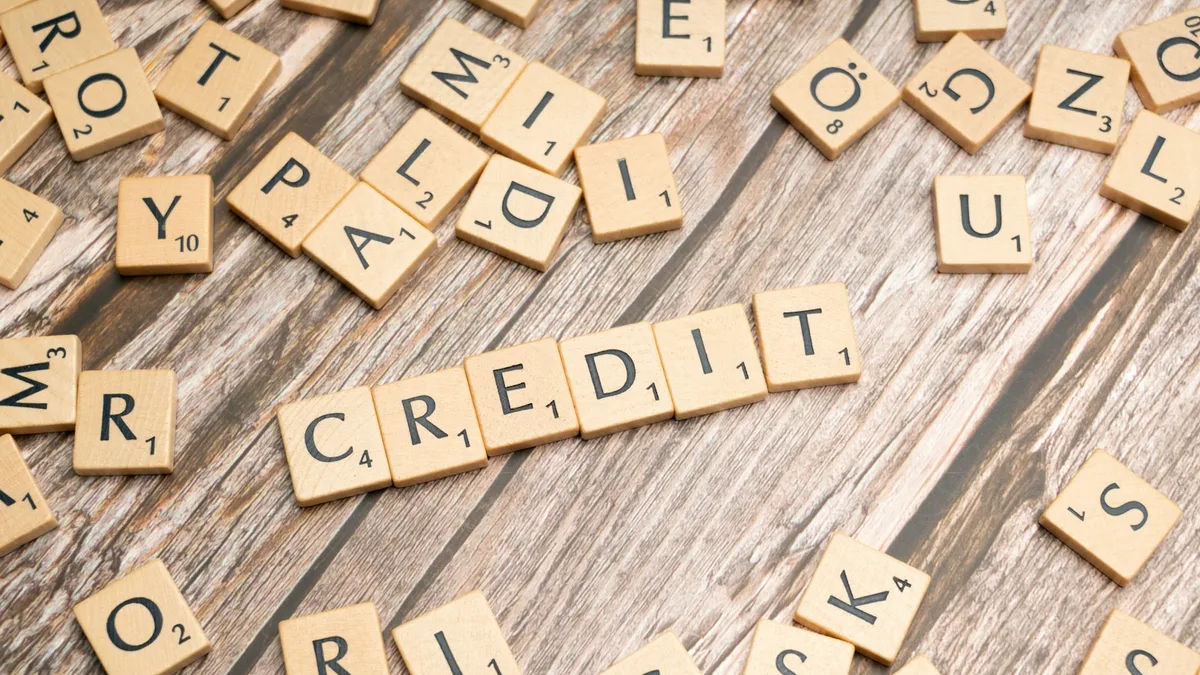 Lettered tiles spelling the word credit surrounded by scattered letters, representing the credit reporting consequences of a timeshare default