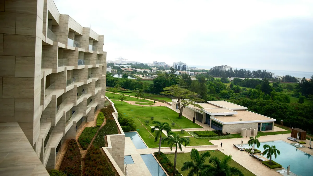 A resort building overlooking landscaped grounds and a pool, representing the stay an owner should price directly against total exchange and ownership costs