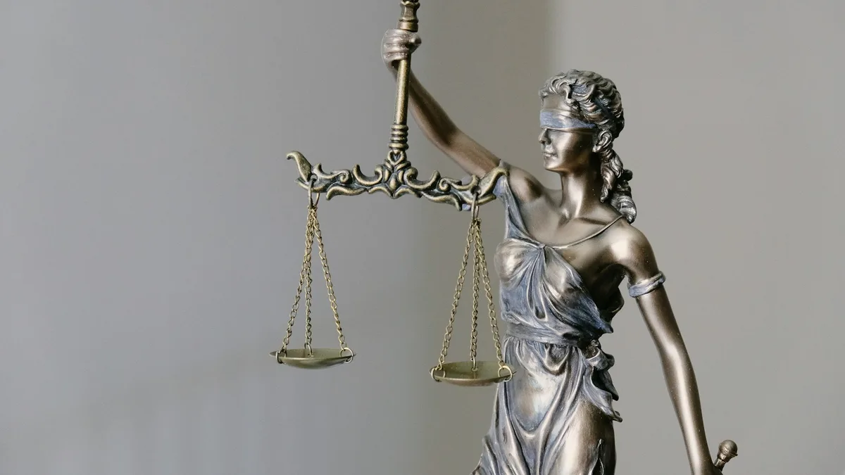 A statue of Lady Justice holding balanced scales, representing the legal protections available to U.S. timeshare owners