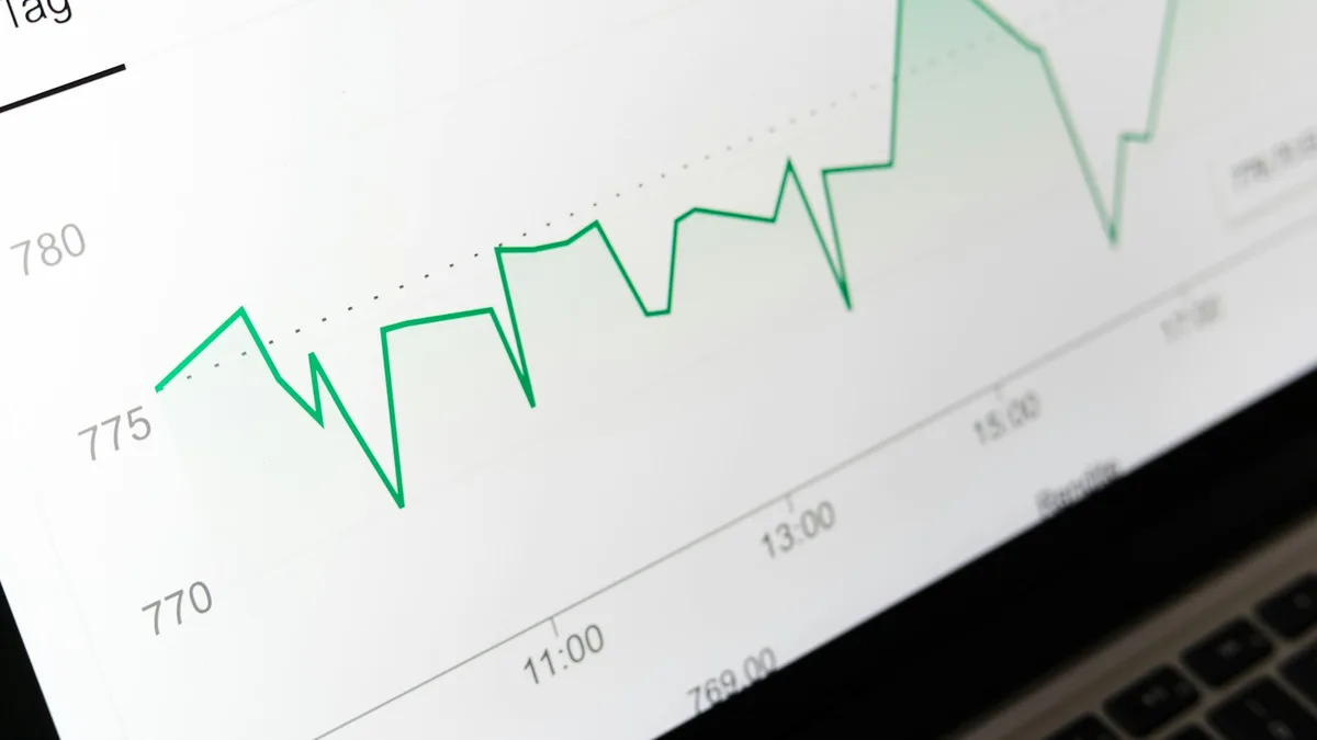 An upward-trending green line chart on a screen, representing timeshare maintenance fees that rise year after year at or above inflation