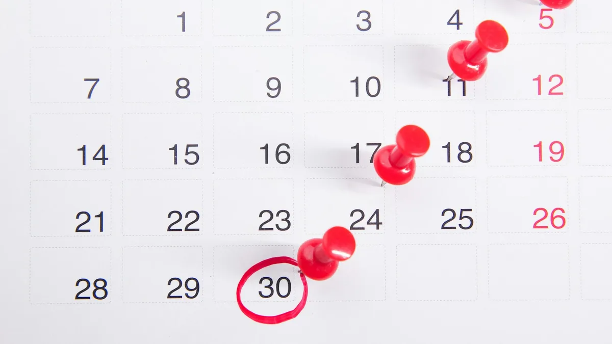 A calendar with red pins and a circled date, representing the limited statutory rescission window a U.S. timeshare buyer must act within