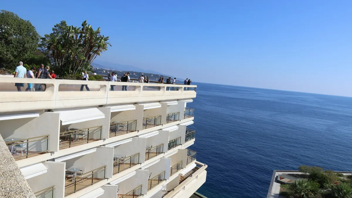 Rows of resort balconies overlooking the deep blue sea, representing the vacation property a U.S. heir can inherit through a will, trust, or state inheritance law